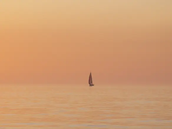 Offshore sailing yacht at sunset after completing navigation training Offshore sailing yacht at sunset after completing navigation training